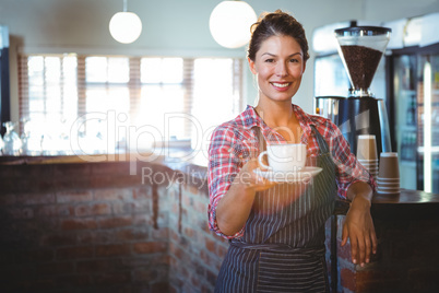 Waitress holding a cup of coffee