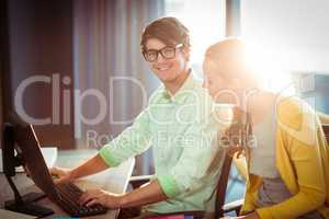 Man working on computer with coworker