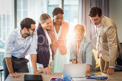 Group of business people interacting using laptop