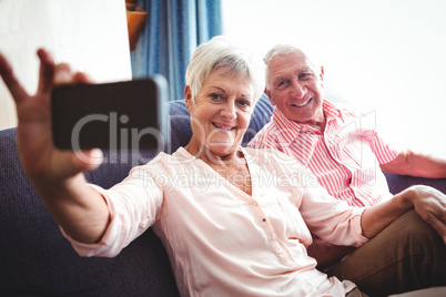 Smiling senior couple taking a selfie