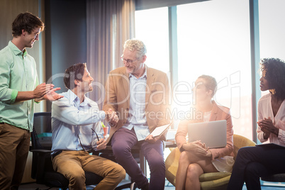 Businessman shaking hands with a coworker