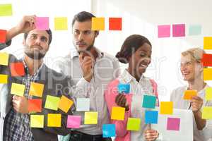Business people looking at adhesive notes