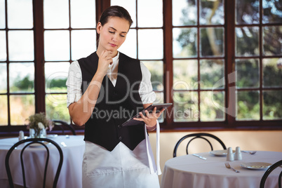 Waitress using digital tablet