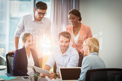 Group of business people interacting using digital tablet