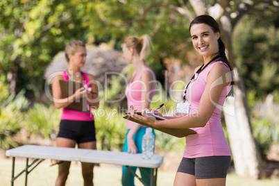 Female volunteer writing in clipboard