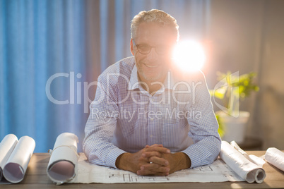 Man sitting with blueprint at his desk