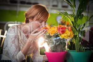 Female florist smelling rose flowers