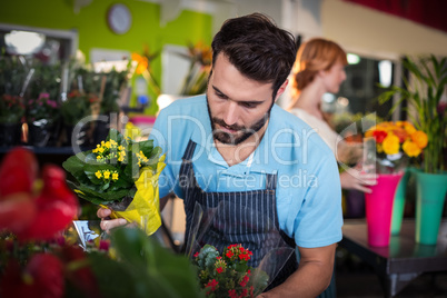 Male florist arranging flower bouquet