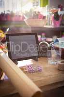 Digital tablet and florist supplies on the wooden table