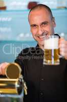 Bar tender holding beer glass