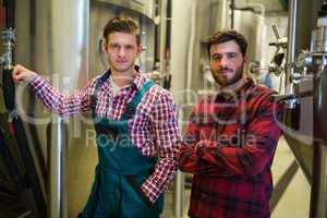 Brewers with arms crossed at brewery