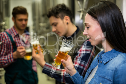 Brewers testing beer at brewery factory