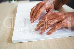 Senior man using braille to read