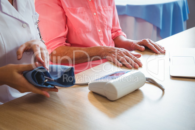 Nurse measuring the blood pressure of a senior woman