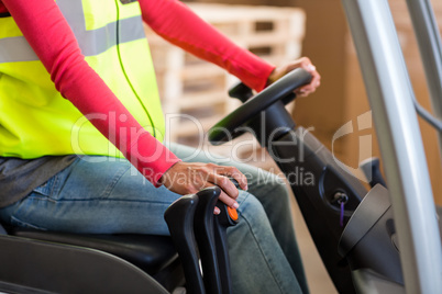 Close up of worker is driving a pallet truck