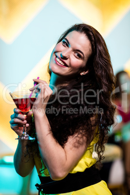 Beautiful woman having a red martini