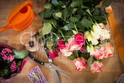 Bouquet of flower material on a wooden worktop