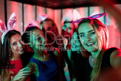 Group of smiling friends posing for a selfie