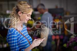 Smiling woman using mobile phone