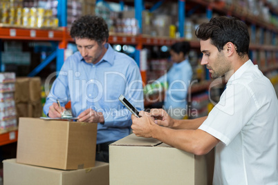 Focus of managers are working in the middle of cardboard boxes