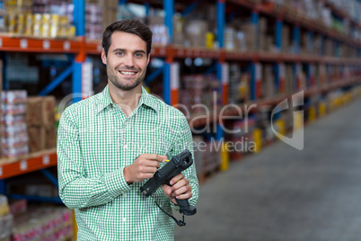 Happy worker holding a tool and smiling