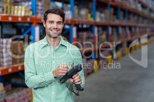 Happy worker holding a tool and smiling