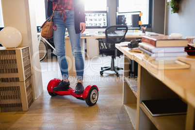 Graphic designer standing on hover board