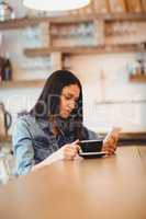 Woman using mobile phone at office