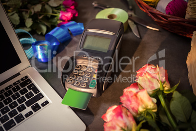 Laptop and credit card terminal on the table