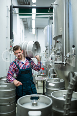 Brewer carrying keg on shoulder