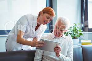 Nurse and senior man using a digital tablet