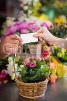 Florist giving visiting card to customer