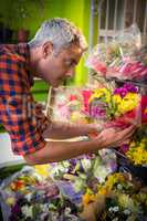 Male florist arranging flower bouquet