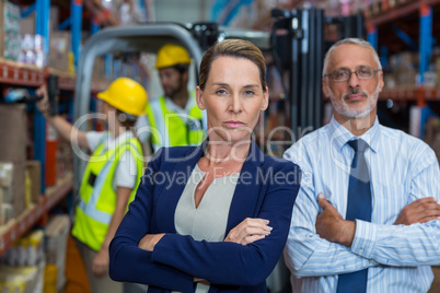 Serious managers are posing with crossed arms