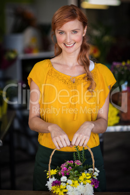 Female florist holding basket of flower