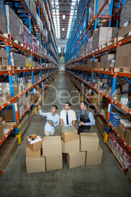High angle view of managers are looking up and pointing shelves