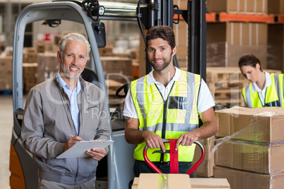 Worker and manager are smiling and posing during work