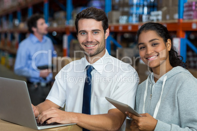 Smiling worker typing on computer