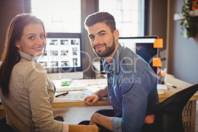 Graphic designers working at desk in the office