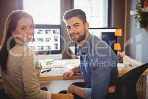 Graphic designers working at desk in the office