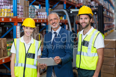 Manager and workers are posing and looking the camera