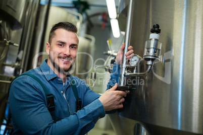Brewer checking pressure at brewery