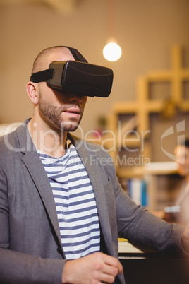 Male graphic designer wearing virtual glasses