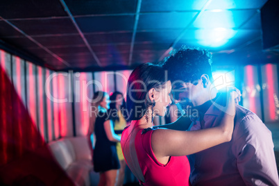 Cute couple dancing together on dance floor