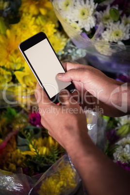 Male florist taking photo of flower bouquet