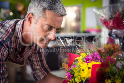 Male florist arranging bouquet of flower