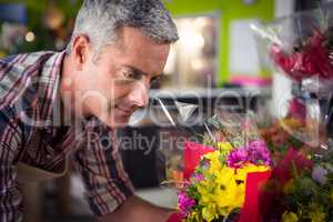 Male florist arranging bouquet of flower
