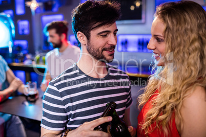 Happy couple toasting a beer bottles