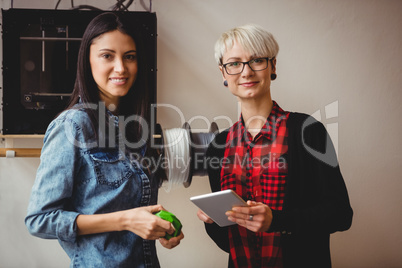 Female graphic designers holding digital tablet