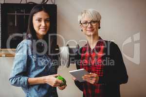 Female graphic designers holding digital tablet